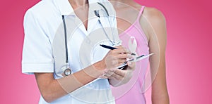 Composite image of portrait of cheerful female doctor writing on clipboard