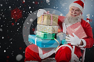 Composite image of portrait of cheerful santa claus holding christmas presents on chair