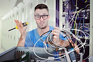 Composite image of portrait of confused it professional with driver and cables in front of ope