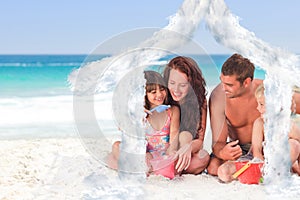 Composite image of portrait of a family at the beach