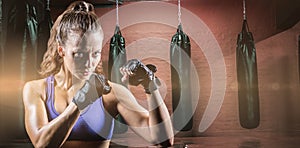 Composite image of portrait of female confident boxer with fighting stance