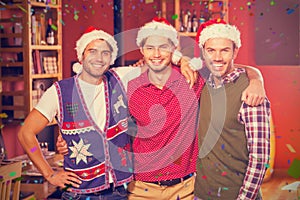 Composite image of portrait of friends with christmas hats