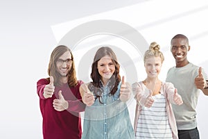 Composite image of portrait of happy business team with thumbs up