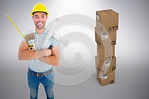 Composite image of portrait of happy manual worker holding various tools