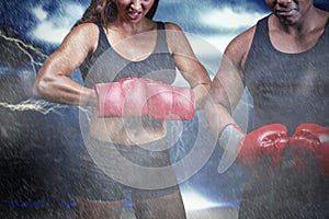 Composite image of portrait of male and female boxers with gloves