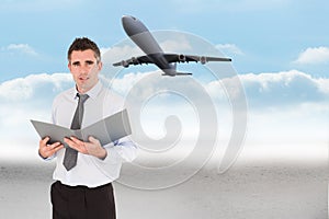 Composite image of portrait of a man holding a binder