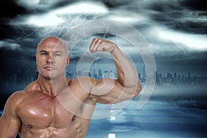 Composite image of portrait of muscular man flexing bicep
