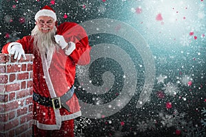 Composite image of portrait of santa claus carrying bag full of gifts by chimney