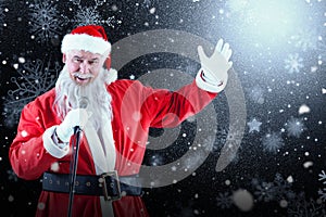 Composite image of portrait of santa claus singing christmas songs