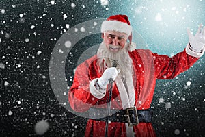 Composite image of portrait of santa claus singing christmas songs