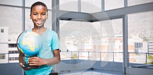 Composite image of portrait of smiling boy holding globe