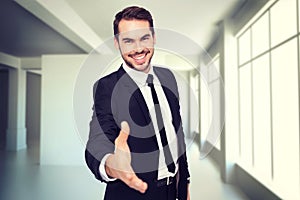 Composite image of portrait of smiling businessman offering handshake