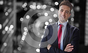 Composite image of portrait of smiling businessman standing with arms crossed