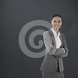 Composite image of portrait of smiling businesswoman standing arms crossed