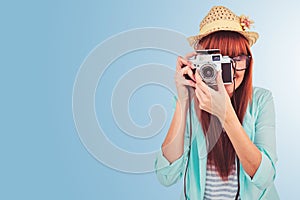 Composite image of portrait of a smiling hipster woman holding retro camera