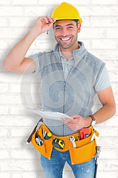 Composite image of portrait of smiling manual worker holding clipboard