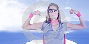 Composite image of portrait of smiling woman in superhero costume while flexing muscles