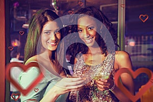 Composite image of portrait of two women having cocktail