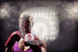Composite image of portrait of woman fighter with gloves