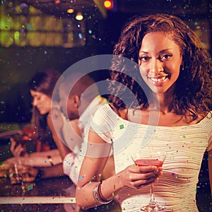 Composite image of portrait of young woman having cocktail at bar counter