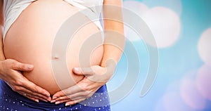 Composite image of pregnant woman holding her bump