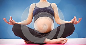 Composite image of pregnant woman sitting on mat in lotus pose