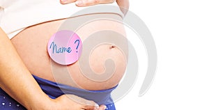 Composite image of pregnant woman with sticker on bump