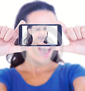 Composite image of pretty brunette winking at camera