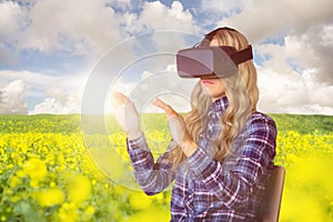 Composite image of pretty casual worker using oculus rift photo