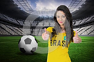 Composite image of pretty football fan in brasil tshirt