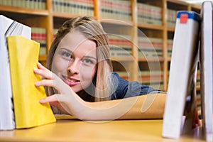 Composite image of pretty student in the library