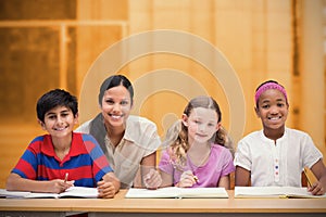 Composite image of pretty teacher helping pupils in library