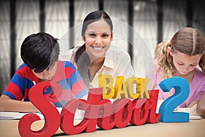 Composite image of pretty teacher helping pupils in library