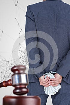 Composite image of rear view of businessman with handcuff and banknotes