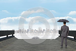 Composite image of rear view of classy businessman holding grey umbrella