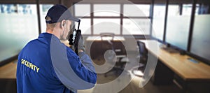 Composite image of rear view of focused security officer talking on walkie talkie