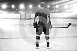 Composite image of rear view of hockey player at ice rink