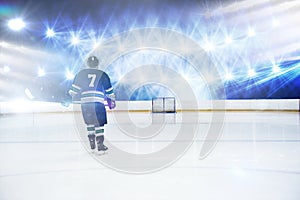 Composite image of rear view of player holding ice hockey stick