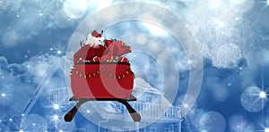 Composite image of rear view of santa claus riding on sled with gift box