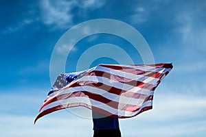 Composite image of rear view of sportsman posing with an american flag