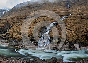 Composite image of red deer stag in Stunning Winter landscape image of River Etive and Skyfall Etive Waterfalls in Scottish photo