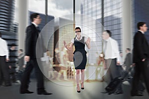 Composite image of redhead businesswoman in a blindfold