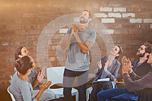 Composite image of rehab group applauding delighted man standing up