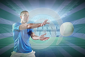 Composite image of rugby player catching the ball