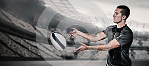 Composite image of rugby player catching ball