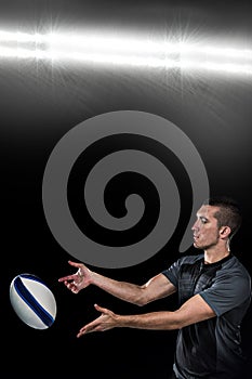 Composite image of rugby player catching ball