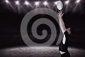 Composite image of rugby player catching a rugby ball