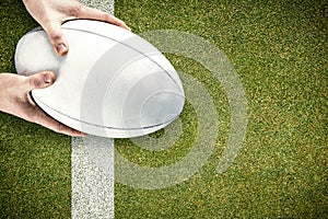 Composite image of rugby player catching a rugby ball