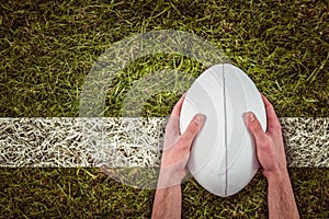 Composite image of rugby player catching a rugby ball