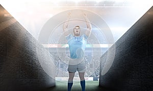 Composite image of rugby player cheering and pointing